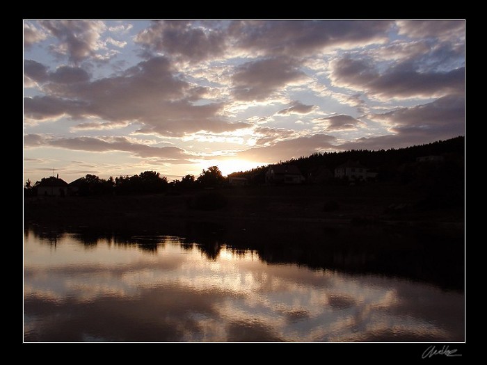 Sunset above water dam