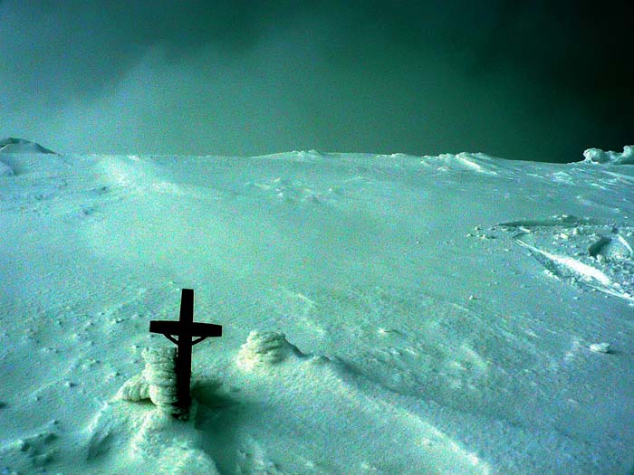 small cross on a big mountain